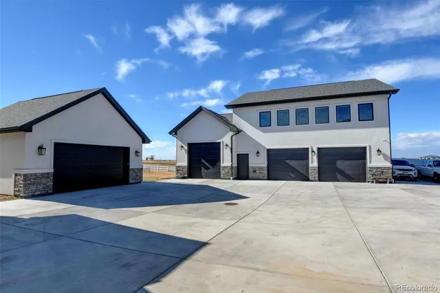 a front view of house with yard and garage