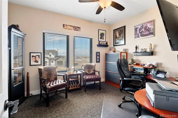 a view of a livingroom with workspace and a window