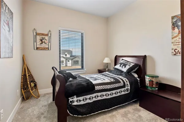 a bed room with a bed and a chair
