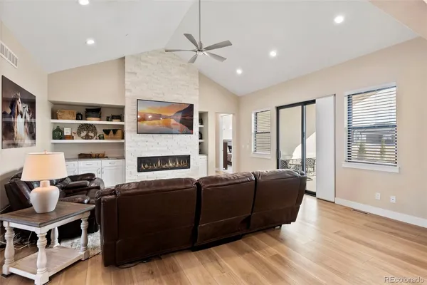 a living room with furniture a flat screen tv and a window