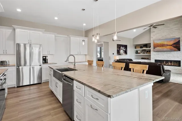 a kitchen with stainless steel appliances granite countertop a sink stove and refrigerator