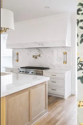 a kitchen with a refrigerator and white cabinets