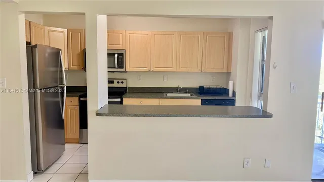 a kitchen with stainless steel appliances granite countertop a refrigerator and a stove