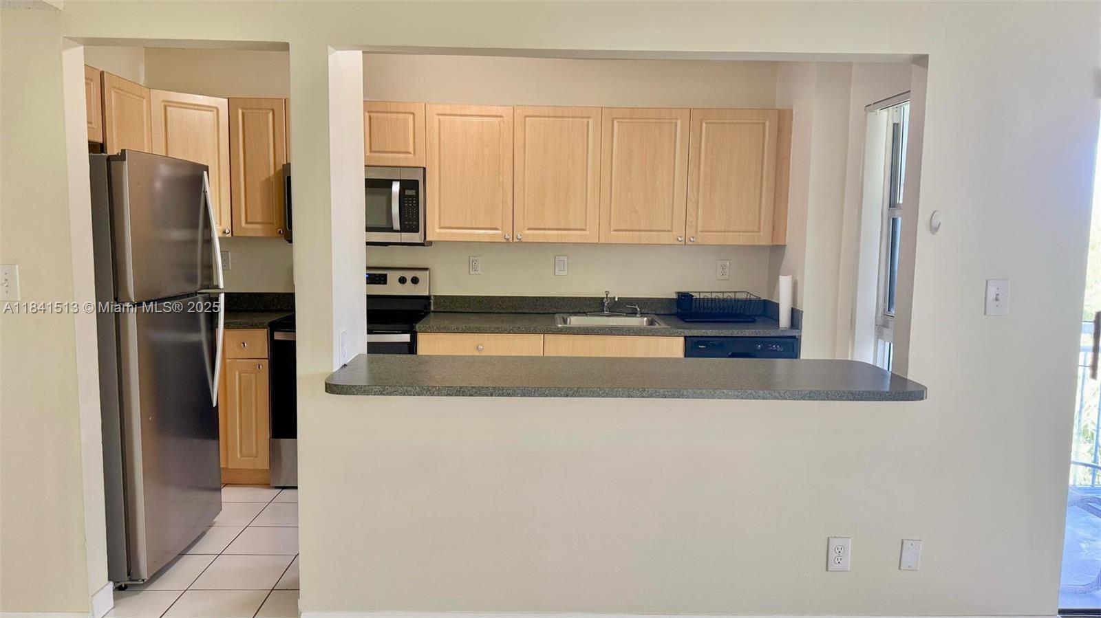 605 South Pine Island Road, Unit 405A Plantation, FL 33324 - Photo 3 of 17 a kitchen with stainless steel appliances granite countertop a refrigerator and a stove