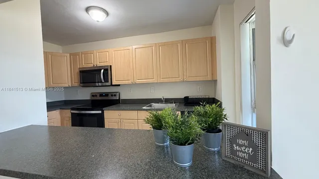 a kitchen with a microwave a stove and cabinets