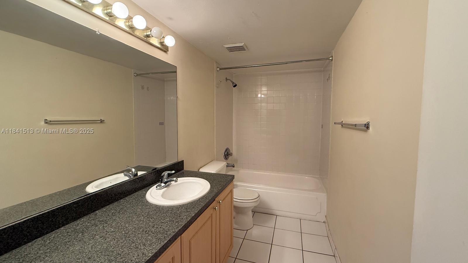 605 South Pine Island Road, Unit 405A Plantation, FL 33324 - Photo 9 of 17 a bathroom with a granite countertop sink a mirror and a shower