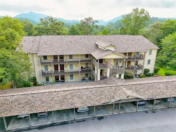 a view of a hallway with workspace and mirror