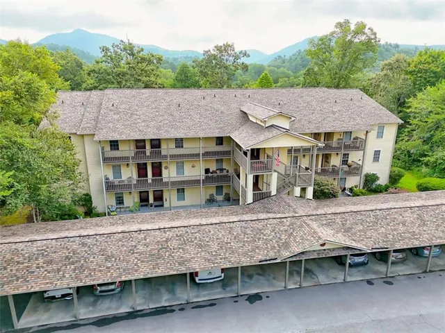 a view of a hallway with workspace and mirror