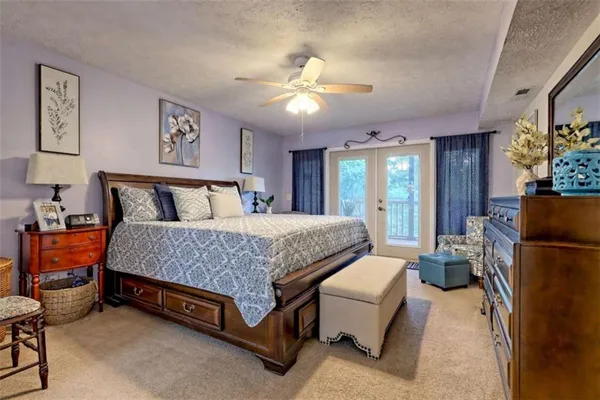 a view of walk in closet with clothes