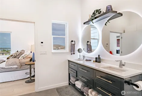 a bedroom with a bed and a painting on the wall