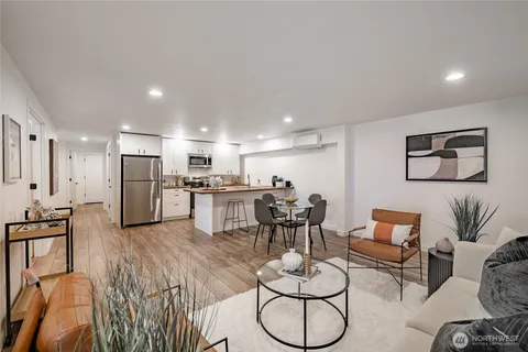 a large kitchen with lots of counter space and wooden floor