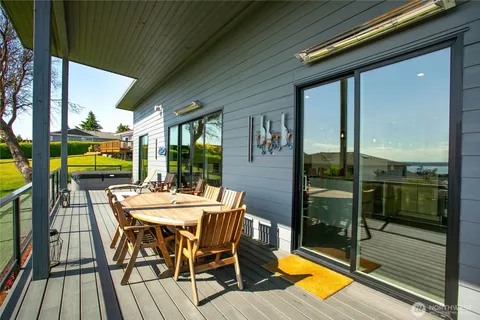 a backyard of a house with barbeque oven and outdoor seating