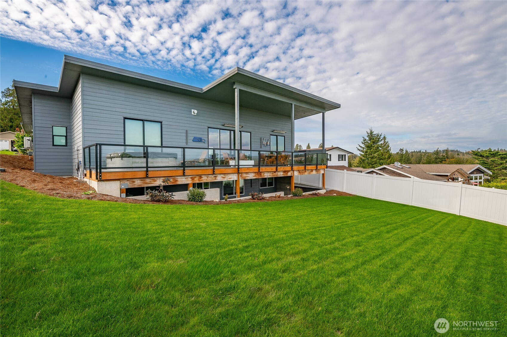 8068 Niska Road Blaine, WA 98230 - Photo 32 of 40 a backyard of a house with barbeque oven and outdoor seating