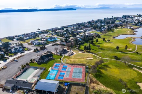 a view of a lake with houses in the back