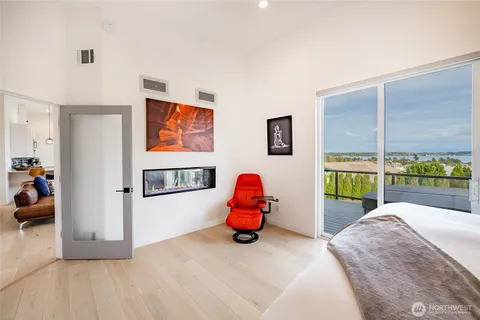 a bedroom with a bed and painting on the wall