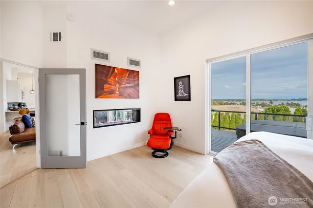 a bedroom with a bed and painting on the wall
