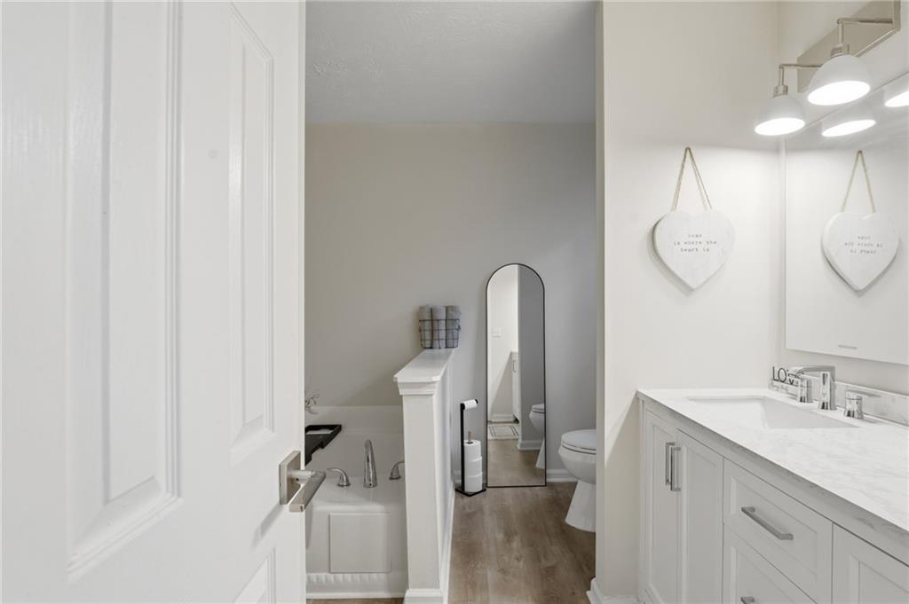 404 Brooks Street Dallas, GA 30157 - Photo 17 of 38 a bathroom with a sink vanity and a mirror