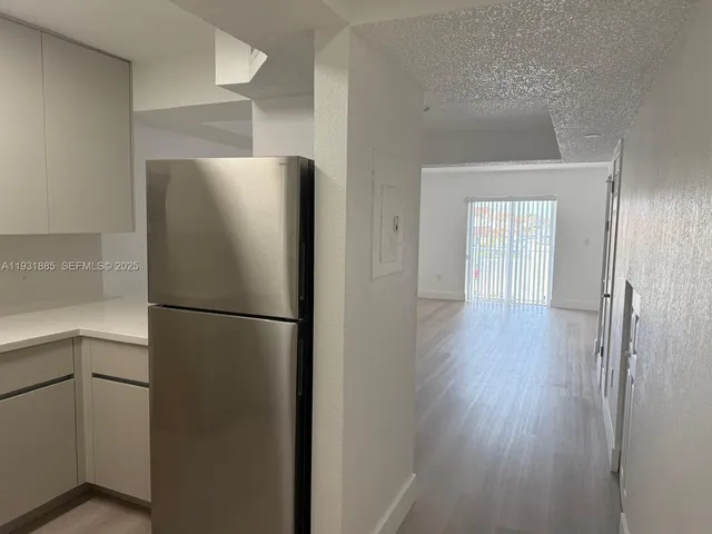 a white refrigerator freezer sitting in a kitchen