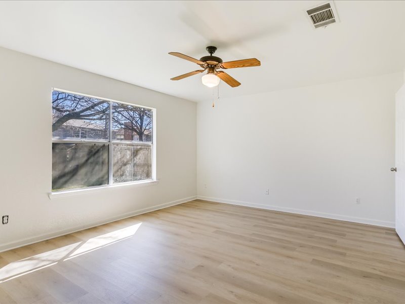 817 Smoke Signal Pass Pflugerville, TX 78660 - Photo 5 of 10 Unfurnished room with light wood-style flooring and ceiling fan