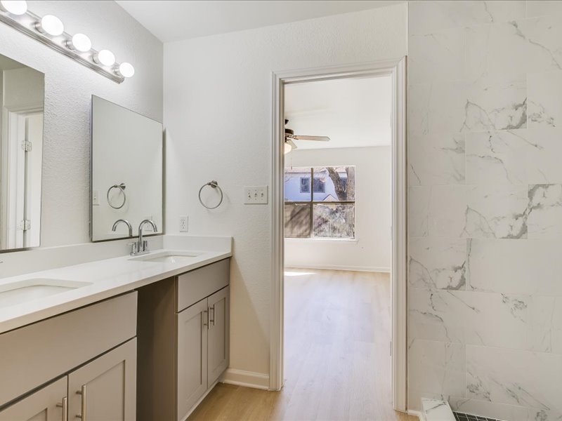 817 Smoke Signal Pass Pflugerville, TX 78660 - Photo 6 of 10 Bathroom with double vanity, light wood finished floors, and ceiling fan