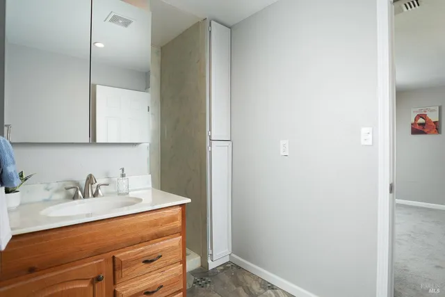 wooden floor in an empty room with a bathroom