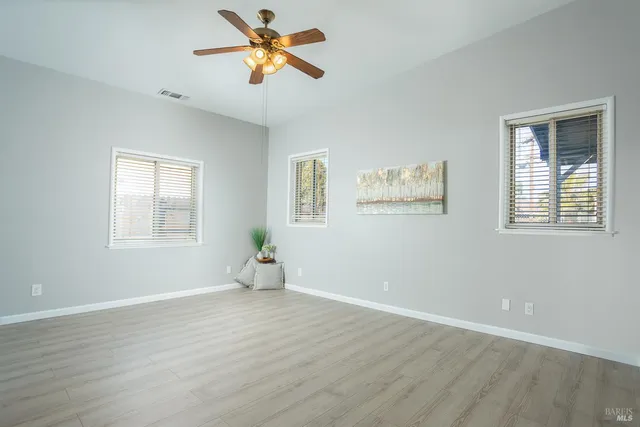 a bathroom with a granite countertop sink a toilet and a mirror