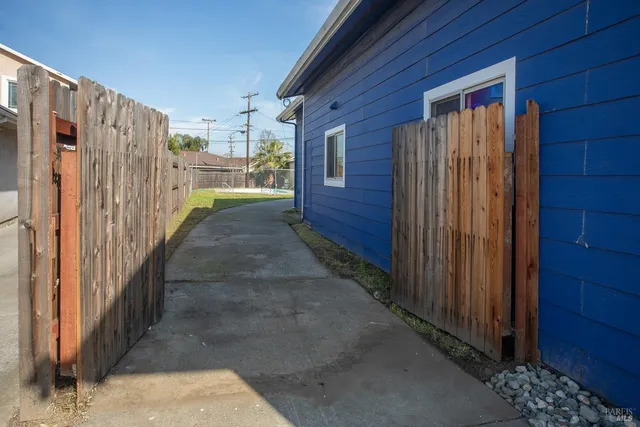 a view of a house with wooden fence