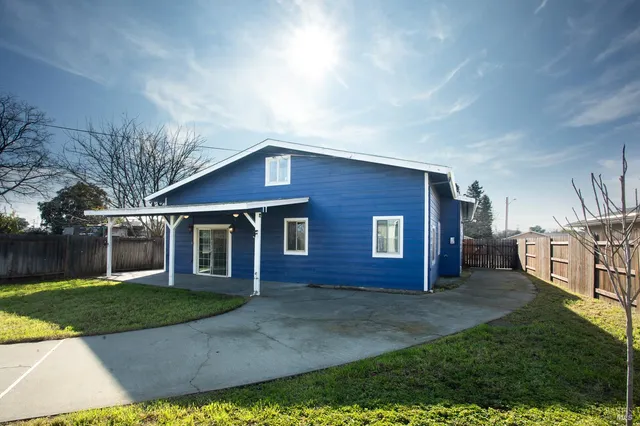 a view of a house with a swimming pool and a yard