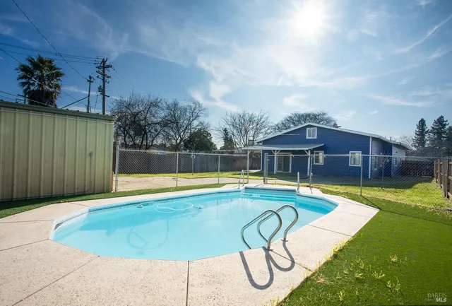 a view of a backyard with a small pool