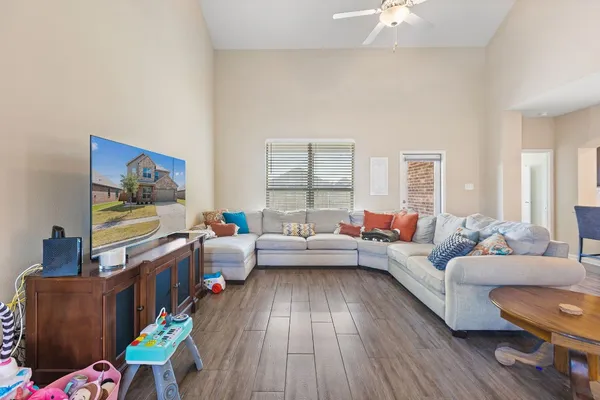 a living room with furniture and a wooden floor