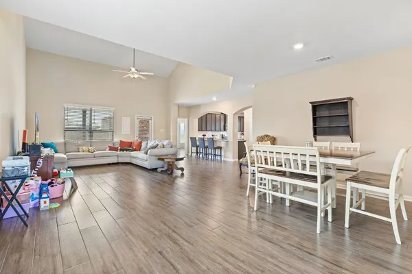 a living room with furniture and a wooden floor