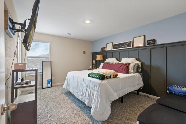 a bedroom with a bed closet and a mirror