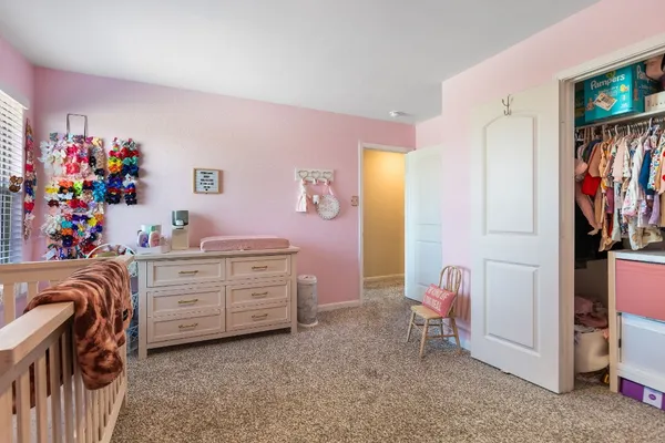 a bed room with a bed and a television