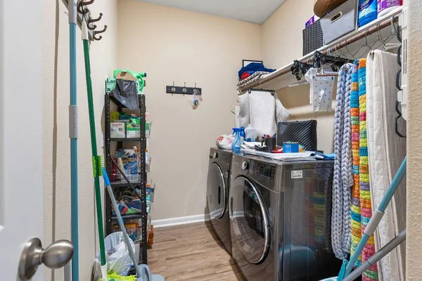 a view of walk in closet with clothes and shoes
