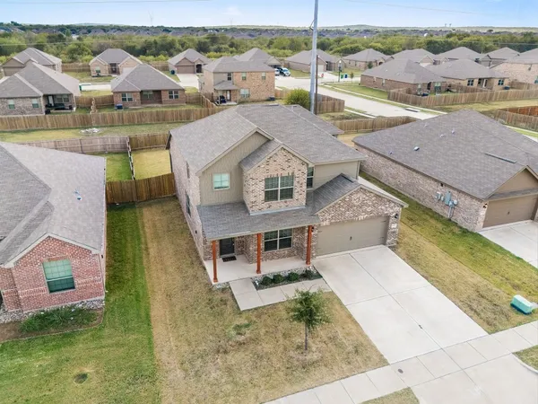 an aerial view of a house with a big yard