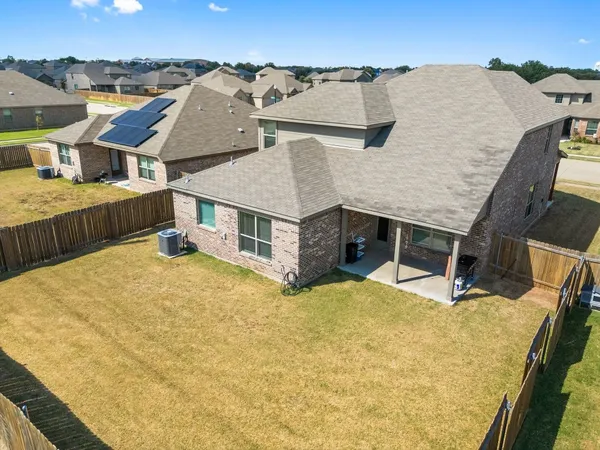 an aerial view of a house with a yard