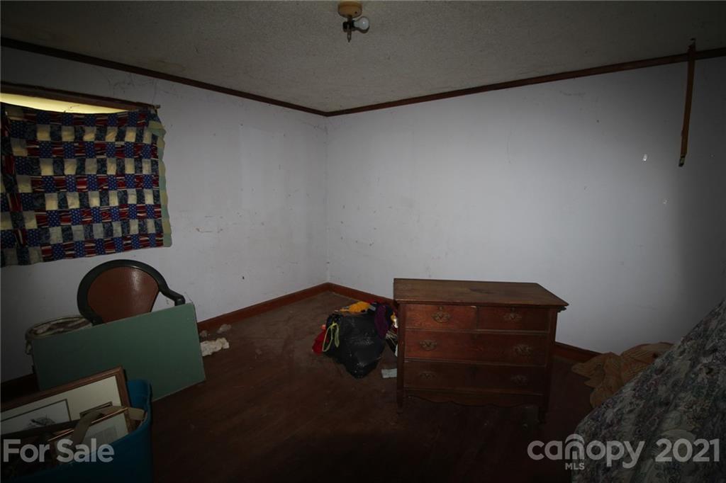 118 Furr Road, Unit 1 80 Cleveland, NC 27013 - Photo 14 of 26 a room with a chair and potted plant on the wall