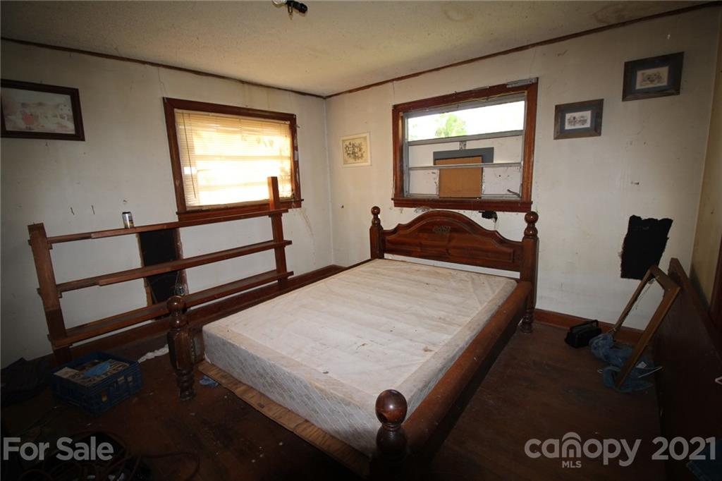 118 Furr Road, Unit 1 80 Cleveland, NC 27013 - Photo 15 of 26 a bedroom with a bed and wooden floor