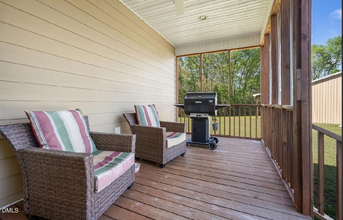 5780 McArthur Road Broadway, NC 27505 - Photo 37 of 40 a living room with furniture and a floor to ceiling window