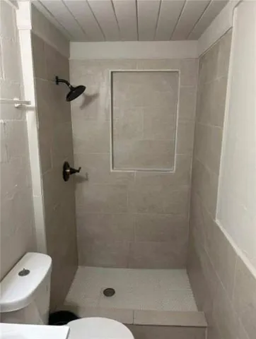 a bathroom with a toilet and shower