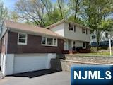 64 East Century Road Paramus, NJ 07652 - Photo 1 of 19 a front view of a house with garden
