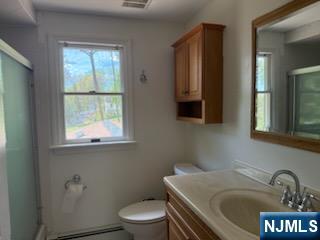 64 East Century Road Paramus, NJ 07652 - Photo 13 of 19 a bathroom with a sink a toilet and mirror