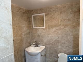 64 East Century Road Paramus, NJ 07652 - Photo 16 of 19 a bathroom with a sink toilet and mirror