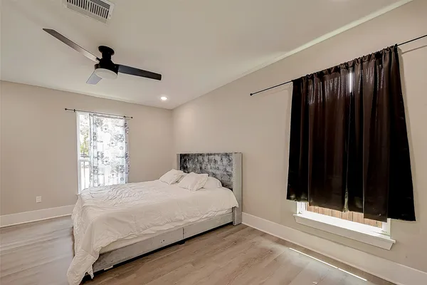 a bedroom with a bed and a window