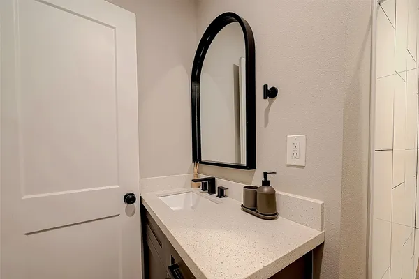 a bathroom with a sink and a mirror
