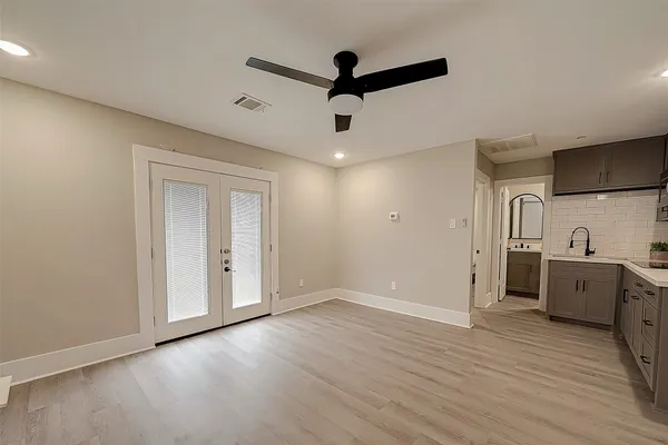 a view of a kitchen with wooden floor and a sink