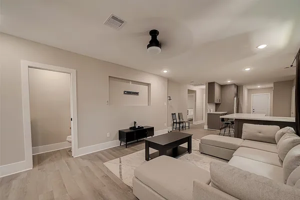 a living room with furniture and a wooden floor