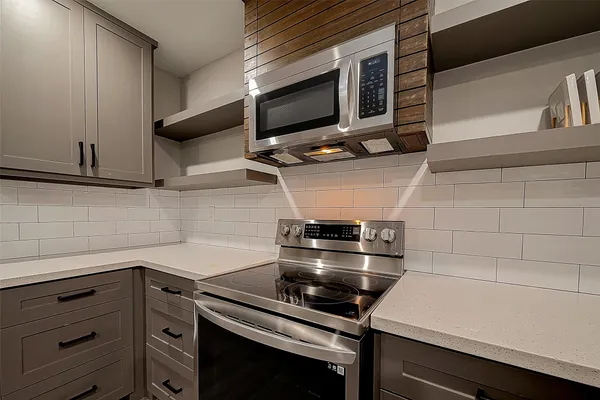 a kitchen with a stove and a microwave