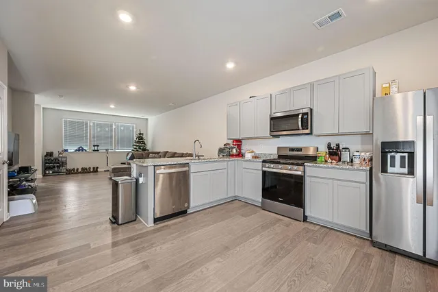a kitchen with stove cabinets and refrigerator