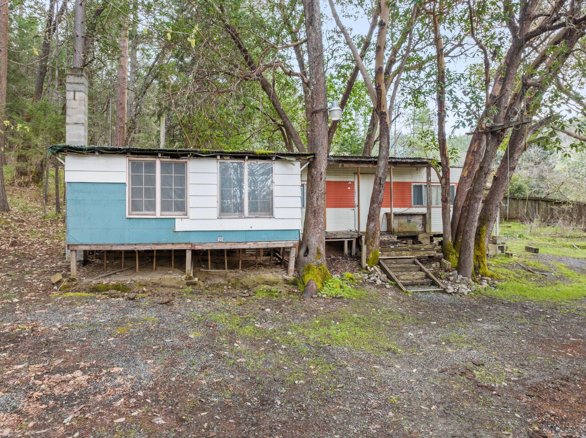 4618 Kane Creek Road Central Point, OR 97502 - Photo 8 of 19 a view of a house with backyard and a tree